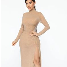 a woman in a long sleeved dress with a high slit skirt and thigh high heels