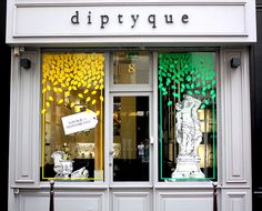 a store front with the words diptyque painted on it's glass windows