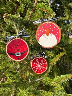 three christmas ornaments hanging from a tree