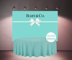 a table with a white bow on it in front of a light blue backdrop that says bride and co