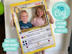 two young children holding up a photo frame