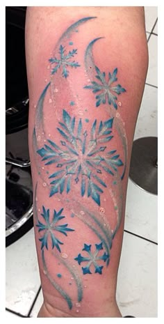 this is a snowflake tattoo on someone's leg