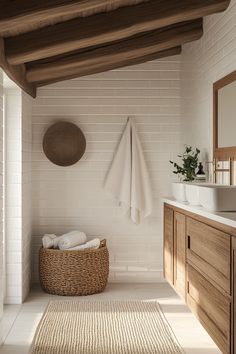 a bathroom with white tile walls and wooden cabinets, a wicker basket on the floor