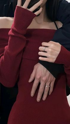 a woman in a red dress is covering her face with her hands