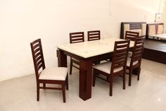 a dining room table with six chairs around it