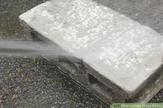 a fire hydrant spewing out water onto the ground next to a sidewalk