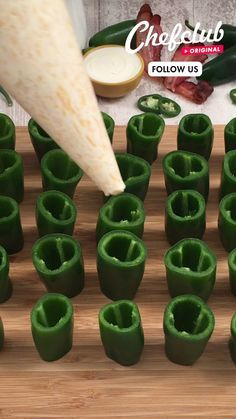 green peppers being cut into small pieces on a cutting board