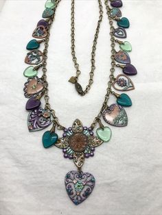 Vintage  Glass Works Studios                                      (4) Brass tone Chain & Charms Necklace   necklace features many charms, glass crystals and enamel work in a floral and heart theme design. Necklace overall length is apx 32" Please see all photos for measurements and visual details. Item is new / never worn stock from jewelry store that closed in 2002 Item is described to the best of my ability, items may have tarnish / patina from storage. Any props used in photos are not included unless stated otherwise. I will gladly combine shipping for more than 1 item when possible but must let us know before sending payment. Please visit my ebay store for other items that will be added frequently.  Thank you. Antique Jewelry Necklace, Theme Design, Colorful Heart, Vintage Watches, Jewelry Stores, Antique Jewelry, Vintage Antiques, Charm Necklace, Jewelry Watches