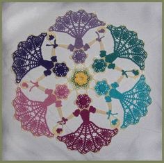 an embroidered doily is shown with different colors and designs in the shape of people