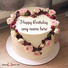 a heart shaped cake with flowers on it and the words happy birthday any name here