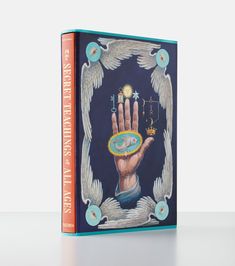 a book with an image of a hand holding the cross and two angels above it