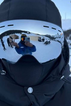 a person wearing ski goggles taking a selfie