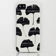 an iphone case with black and white flowers on it's back cover, in front of a white background