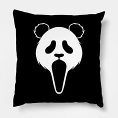 a black and white pillow with a panda bear face on it's front side