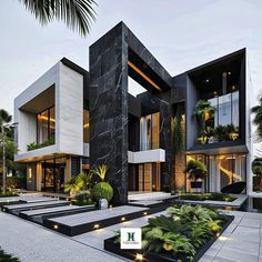 a large modern house with black and white exterior, surrounded by greenery in the foreground