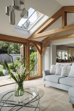 a living room filled with furniture and a skylight