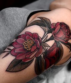 a woman with a flower tattoo on her arm