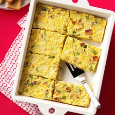 an egg casserole is shown in a white dish