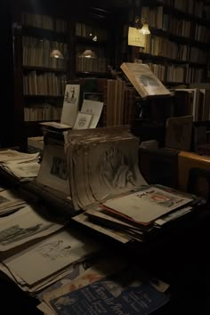 many books are stacked on top of each other in front of a bookcase full of books