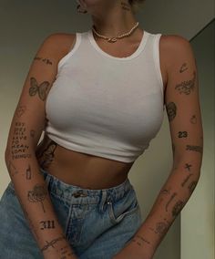 a woman with tattoos on her arms and chest