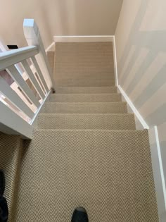 there is a pair of black shoes on the carpeted stairs in front of an open door