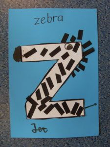 the letter z is for zebra on a blue paper with black and white lines in it