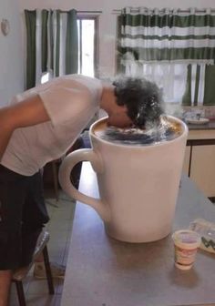 a woman drinking out of a coffee cup with the caption when you need that little bit of cafine, first thing in the morning