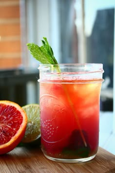 a grapefruit and limeade drink in a mason jar on a cutting board