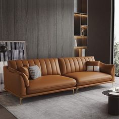 a brown leather couch sitting on top of a rug