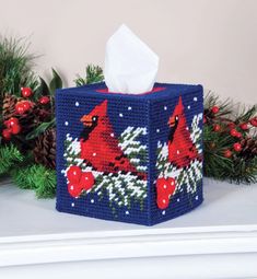 a tissue box decorated with red cardinals and pine cones