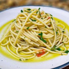 a white plate topped with pasta and sauce