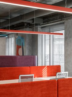 an office with orange and purple couches