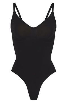 Find SKIMS Seamless Sculpt Thong Bodysuit on Editorialist. Updated for an even better fit, this fan-fave bodysuit from Kim Kardashian's SKIMS offers extra compression at the core and waist to cinch your natural shape. Strategically placed lines flatter your bust and provide definition, and the low back makes it easy to wear under a variety of outfits. Snap closure Scoop neck Adjustable straps Cotton-lined gusset 82% nylon, 18% spandex Machine wash, tumble dry Imported Slim Bodysuit, Body Suits, Birthday Stuff, Xmas List, Of Outfits, Dream Board, Natural Shapes, Christmas 2024, Low Back