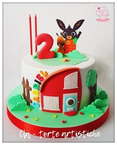 a birthday cake with the number two on it and an animal in the house topper