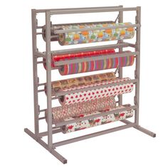 a metal rack with several rolls of fabric on it and two roll holders in the middle