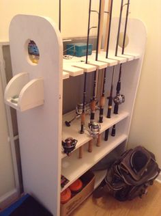 a book shelf filled with lots of different types of fishing rods