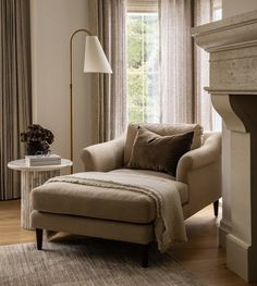 a living room with a chair and ottoman