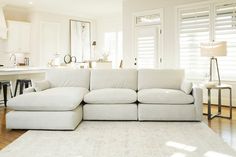 a large white couch sitting on top of a hard wood floor