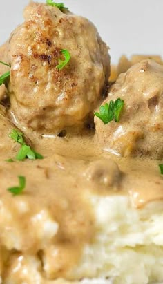 meatballs covered in gravy and garnished with parsley on top