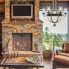 a living room filled with furniture and a flat screen tv mounted to the wall above a fireplace