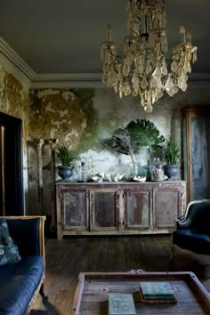 a living room filled with furniture and a chandelier