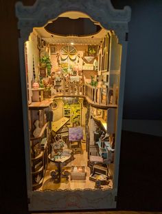 the inside of a doll house with furniture and accessories in it's display case