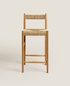 a wooden chair with a woven seat and back rest on a white background, it appears to be empty