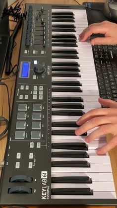 a person playing an electronic keyboard on a table