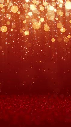 an abstract red background with lots of gold lights and sparkles in the air,