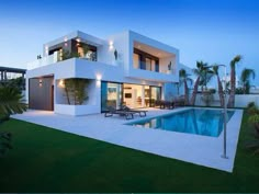 a house with a swimming pool in front of it and palm trees on the other side