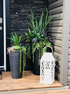 two planters sitting on the front steps of a house