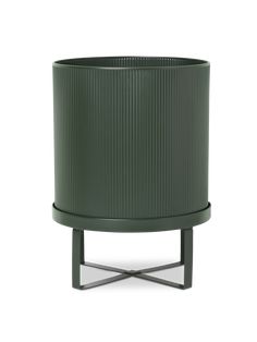 a green planter sitting on top of a metal stand