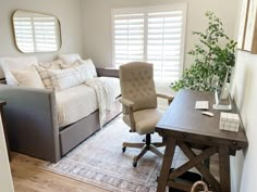 a living room with a couch, chair and desk in it's center area