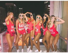 six beautiful women in red bathing suits posing for the camera with their hands on their hips